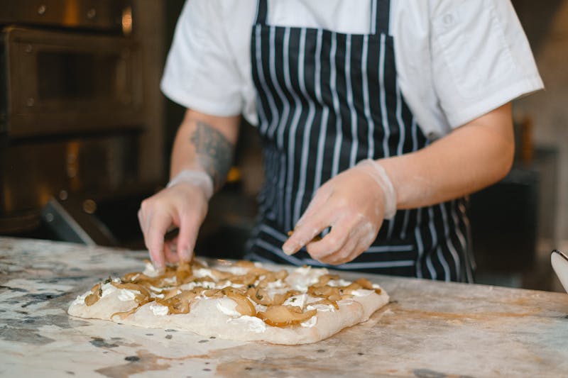 Chef stretching pizza dough